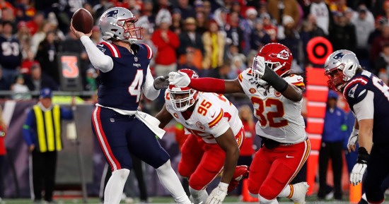 New England Patriots quarterback Bailey Zappe (4) passes under pressure from Kansas City Chiefs defensive tackle Chris Jones (95) and linebacker Nick Bolton (32) during the second half of an NFL football game, Sunday, Dec. 17, 2023, in Foxborough, Mass. (AP Photo/Michael Dwyer)